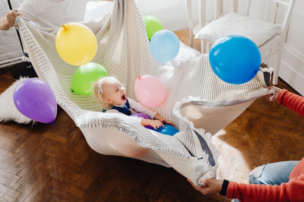 child playing with balloons