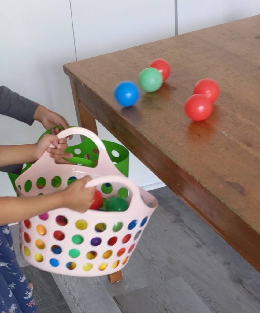 indoor activity for kids using rolling balls down a table