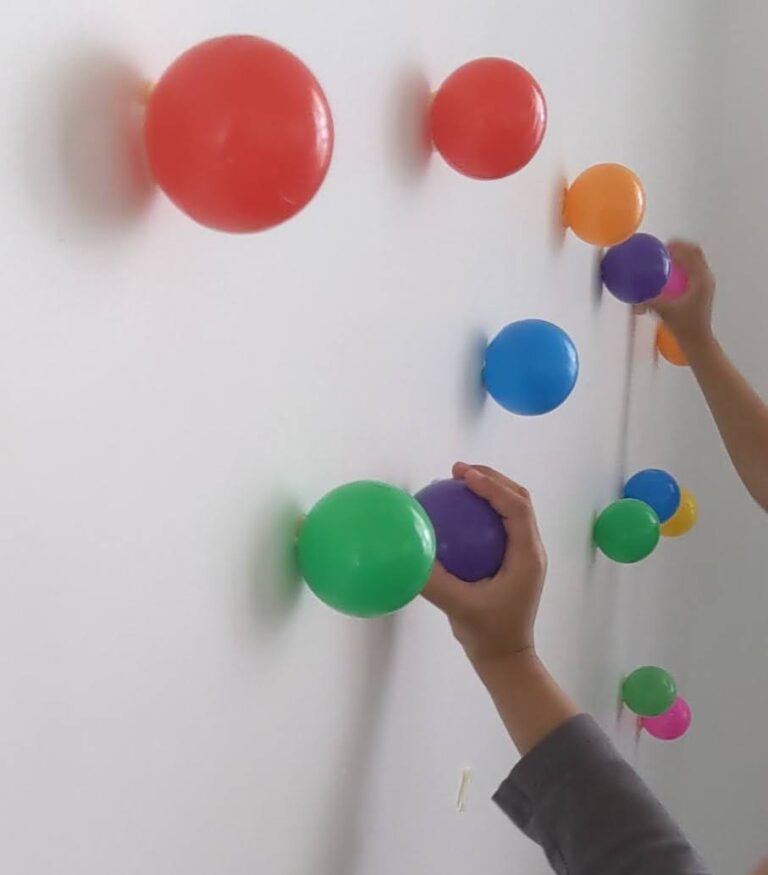 Ball pit ball taped onto wall indoor activity for kids