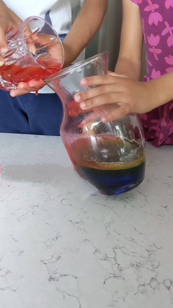 making a liquid rainbow in a glass vase